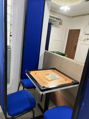 a table in a room with two chairs and a mirror at DP Residence SELAYANG in Batu Caves