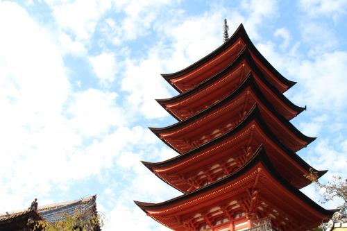 a tall pagoda with the sky in the background at Miyajima Seaside Hotel in Miyajima