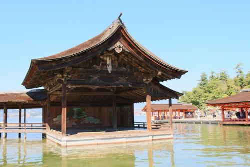 a pagoda on the water in a body of water at Miyajima Seaside Hotel in Miyajima