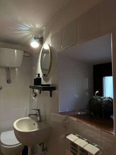 a bathroom with a sink and a toilet and a mirror at RADICl BUSSI in Bussi sul Tirino