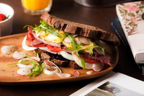 a sandwich on a plate on a table at Ningbo Wanda Moments Hotel in Ningbo