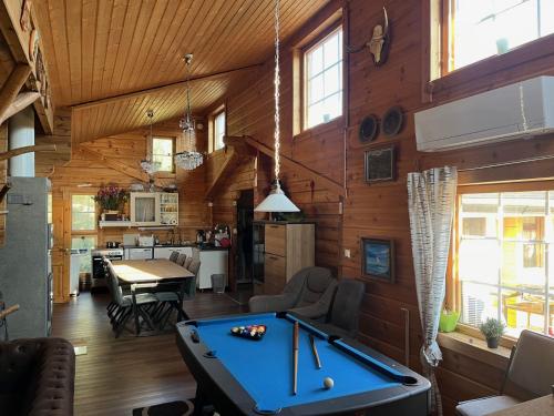 a room with a pool table in a house at Luxury Holiday Home with Private Lake in Vehmaa
