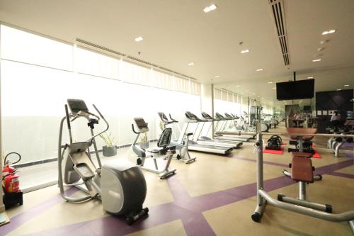 a gym with several treadmills and cardio machines at Mercure Hai Phong in Hai Phong