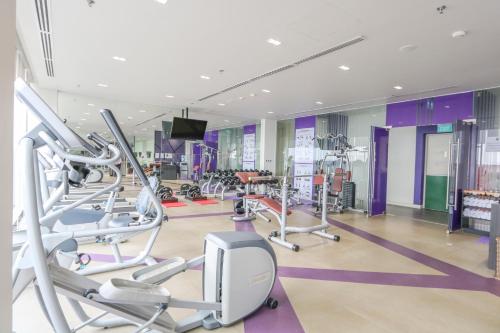 a gym with several treadmills and cardio machines at Mercure Hai Phong in Hai Phong