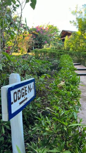 a blue and white street sign in a garden at Manga Soa Lodge in Fascène - Befefika