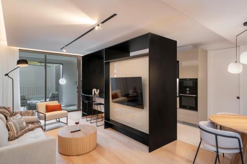 a living room with a couch and a table at Savoy Insular II by An Island Apart in Funchal