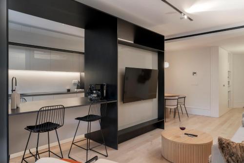 a kitchen and living room with black and white walls at Savoy Insular II by An Island Apart in Funchal