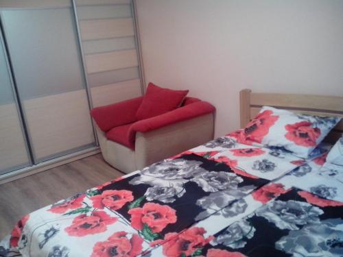 een slaapkamer met een bed en een stoel bij Apartment Syrec in Kiev