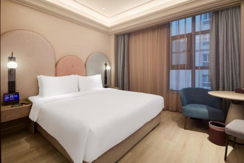Ένα ή περισσότερα κρεβάτια σε δωμάτιο στο Mercure Xian Dazhai Road