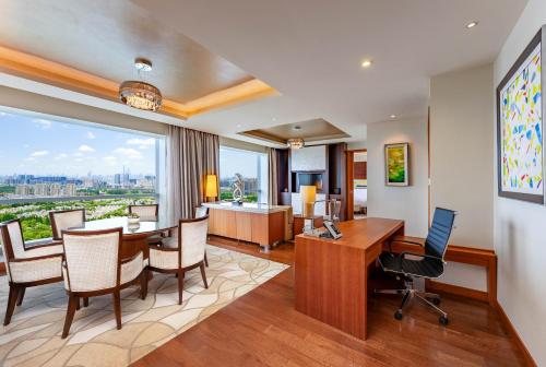 an office with a table and chairs and a large window at Holiday Inn Shanghai Pudong Kangqiao, an IHG Hotel in Shanghai