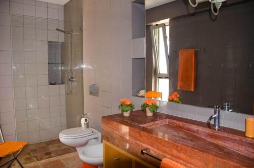 a bathroom with a toilet and a sink at Amazing Windmillhouses in Olhão