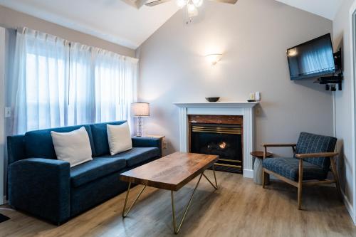 a living room with a blue couch and a fireplace at Inn at Haystack Rock in Cannon Beach