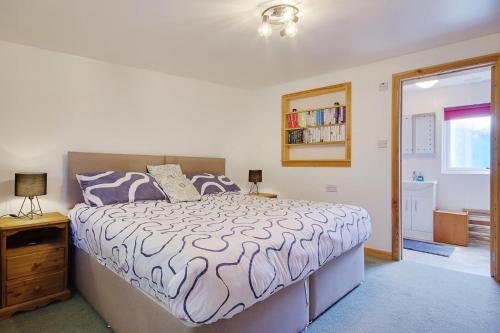 a bedroom with a bed and a book shelf at Hilltop Farm in Sturminster Newton