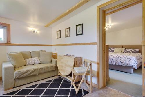 a living room with a couch and a bed at Hilltop Farm in Sturminster Newton