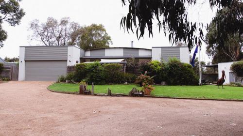 a house with a garden in front of it at Le Pelican - Metung Family Retreat in Metung