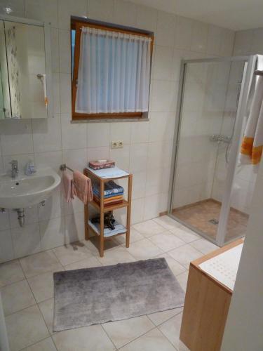 a bathroom with a sink and a shower at Ferienwohnung Auel in Adenau