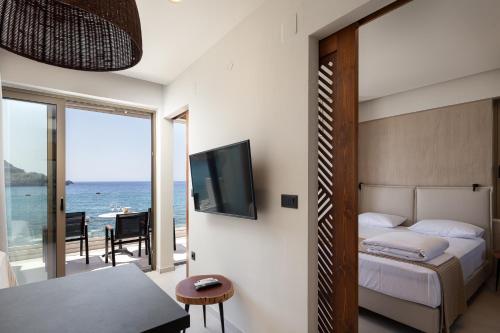 a bedroom with a bed and a view of the ocean at Gio-Ma in Plakias