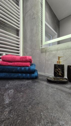 a pile of towels sitting on the floor in a room at Sweet Home Grabieniec Apartment in Łódź