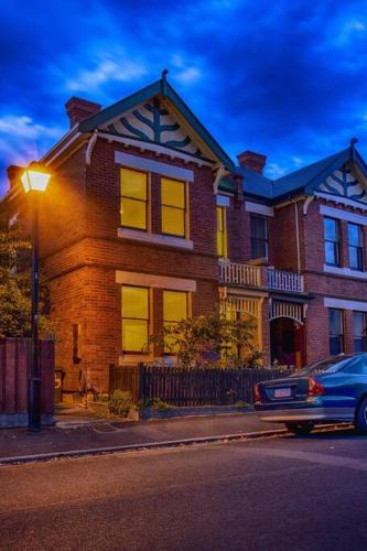 a house with a car parked in front of it at Battery Point Village - Stunning Large Home in Hobart