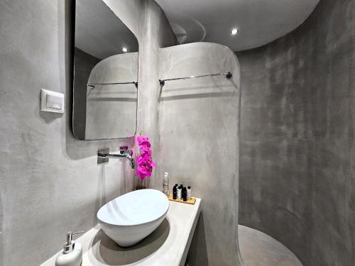 a bathroom with a white sink and a mirror at Coralli Beach Apartments in Mikri Vigla