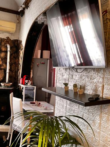 a kitchen with a glass table and a refrigerator at Casa Riccio Di Mare in Favignana