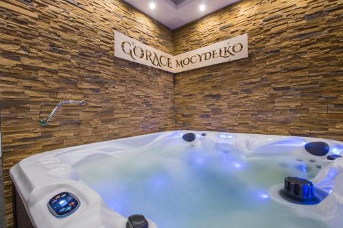 a large bath tub in a room with a sign at Dom Wypoczynkowy u Staszla in Bańska Wyżna