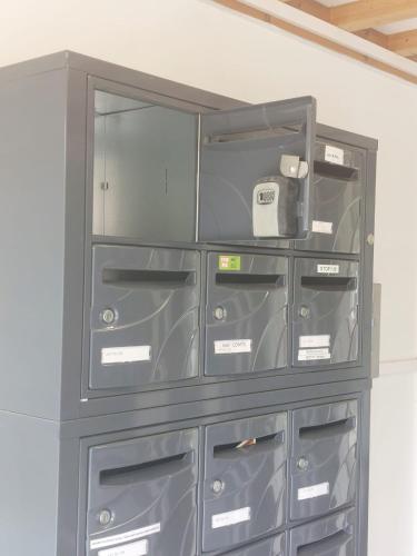 a gray cabinet with glass doors and drawers at Style of Industry in Morbier