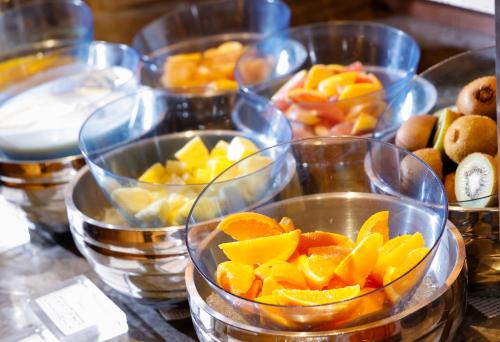 a group of clear bowls filled with fruit on a table at Hotel Okura Fukuoka in Fukuoka