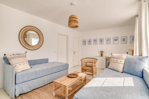 a living room with two blue couches and a table at Villa Bellonia in Naousa