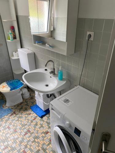 a bathroom with a washing machine and a sink at Erdgeschoss Wohnung 2 Schlafzimmer in Bayreuth