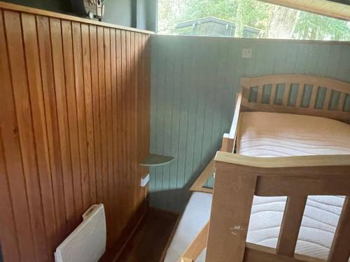a small bedroom with a bed and a window at 11 Tan-y-coed Woodland Lodge in Newcastle Emlyn