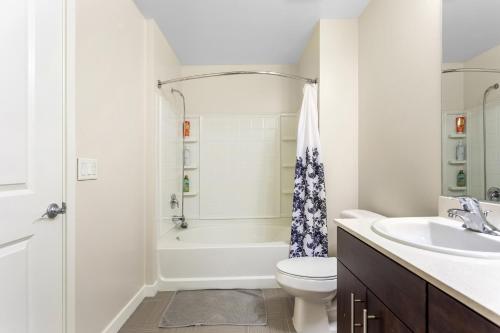 a white bathroom with a sink and a toilet at Luxury 2 Bedroom 2 Bathroom With Fitness Center and Pool in Los Angeles