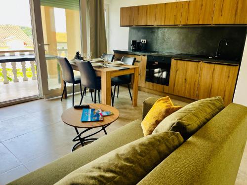 a living room with a couch and a table at Apartments MIRNO MORE, Rogoznica in Rogoznica