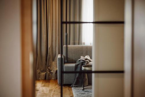 a living room with a chair and a window at Ferienwohnungen Renberg in Maria Alm am Steinernen Meer