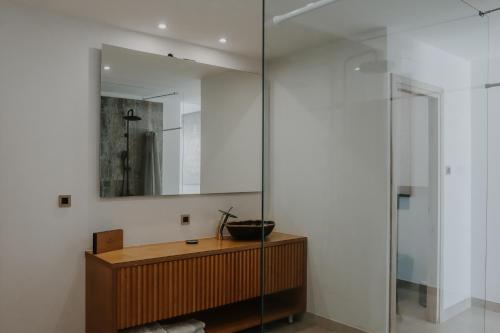 a bathroom with a mirror and a wooden cabinet at BLACK AMBER BOUTIQUE HOTEL in Lampi