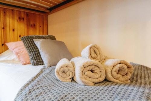 a pile of towels on top of a bed at Le Col Panoramic in La Toussuire