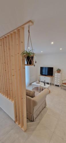 a living room with a couch and a table at Au Jardin d'Olga in Mesnil-Saint-Père