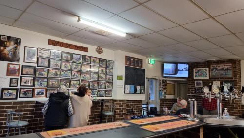 two women standing at a counter in a restaurant at Lockhart Railway Hotel in Lockhart