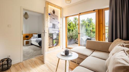 a living room with a couch and a table at Aparthotel Delta Boutique in Kościelisko