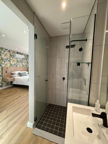 a bathroom with a shower and a sink at Swanemeer Apartments in Cape Town