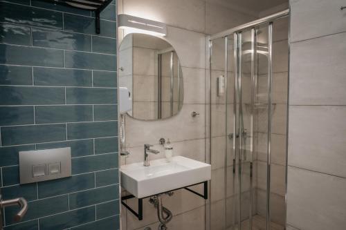 a bathroom with a sink and a shower at Elizabeth Queen Luxury Rooms in Paralia Katerinis