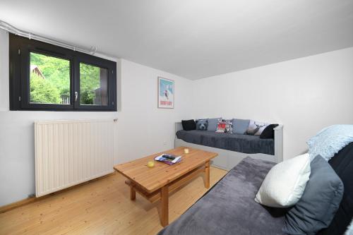 a living room with a couch and a table at Chalet Appartement Les Isards in Saint-Lary-Soulan