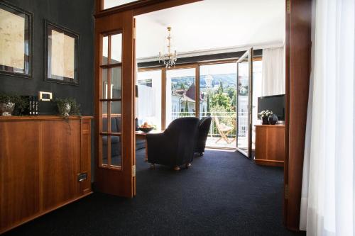 an office with a chair and a desk and a window at Hotel Villa Irma in Merano