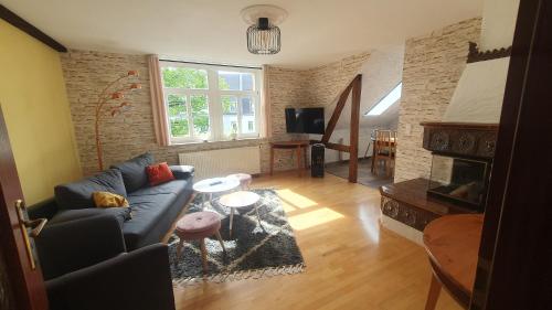 a living room with a couch and a fireplace at Klinkerhaus Treuen in Treuen
