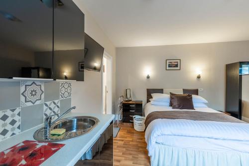 a bedroom with a bed and a sink next to a bed at Roger Ground Guest House - with Onsite Car Parking in Windermere