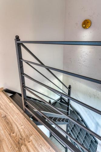 a staircase with a metal railing in a room at La Nostra Villa in Zator