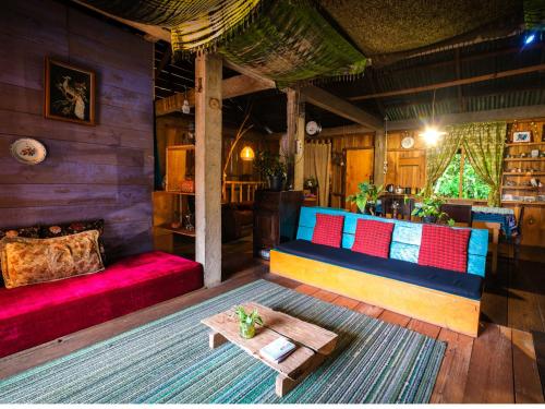 a living room with a couch and a table at Ne Pakku Manja Family Home in Rantepao