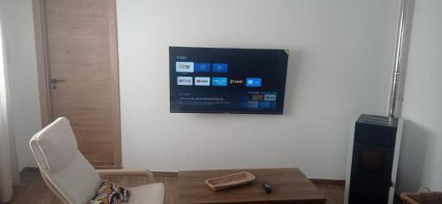 a living room with a tv on a wall at La de Simón in A Guarda