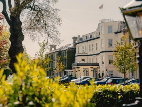 a street with cars parked in front of buildings at The Spa Hotel in Royal Tunbridge Wells