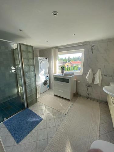a large bathroom with a shower and a sink at Kalmar - Bergavik in Kalmar